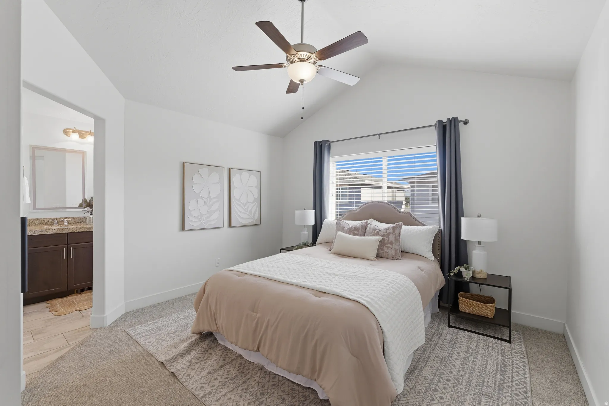 Vaulted ceilings with a ceiling fan, carpeted flooring, and window with blinds
