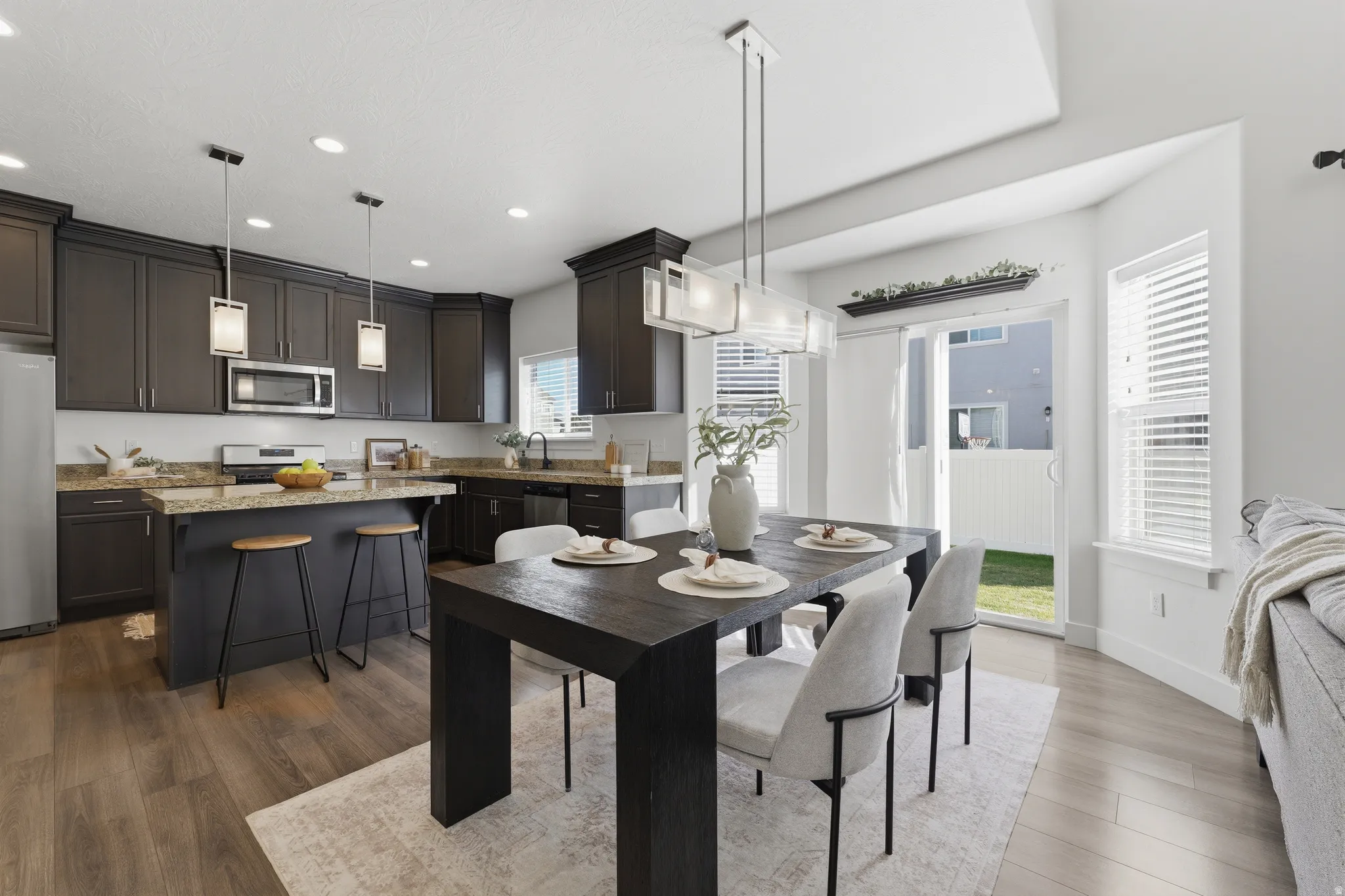 Dark wood-finish cabinetry, granite countertops, and stainless steel appliances