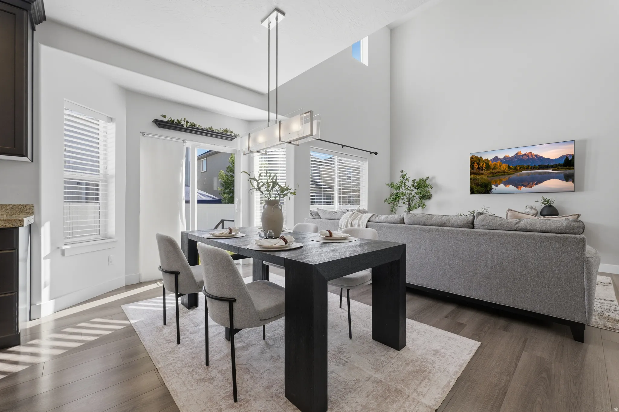 Open-concept living space with vaulted ceiling and wood-finish flooring