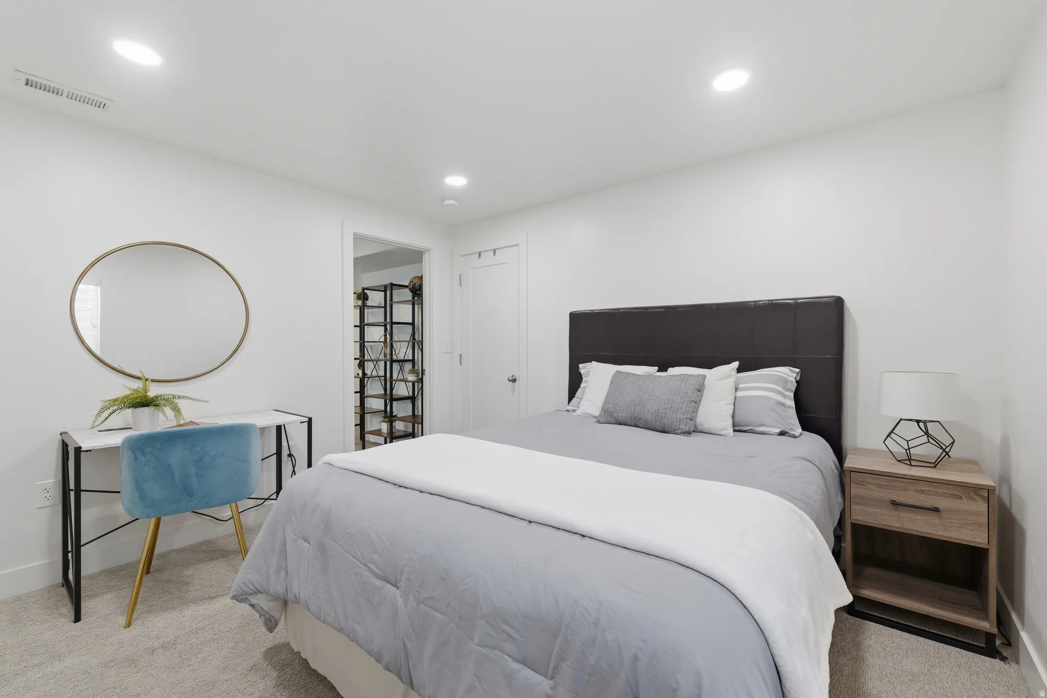 Recessed lighting, light-toned carpeting, and a built-in closet system