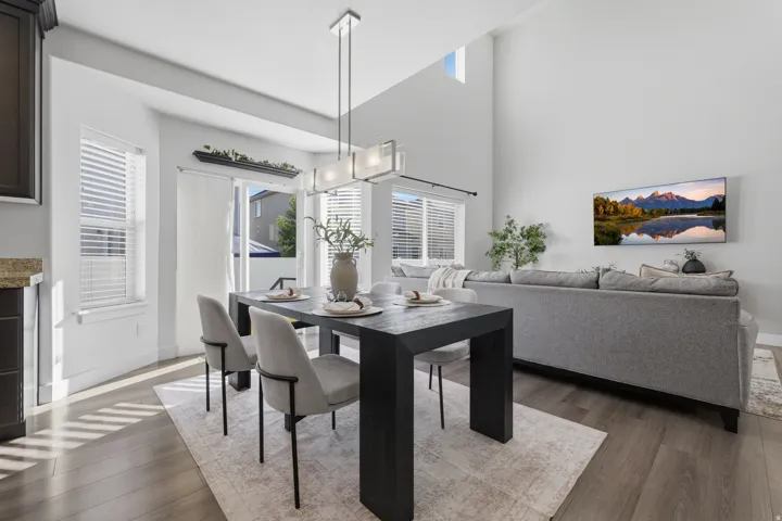 Open-concept living space with vaulted ceiling and wood-finish flooring