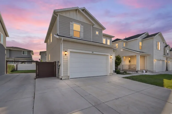 Contemporary exterior with horizontal siding and board-and-batten accents, attached garage, concrete driveway, and private side gate