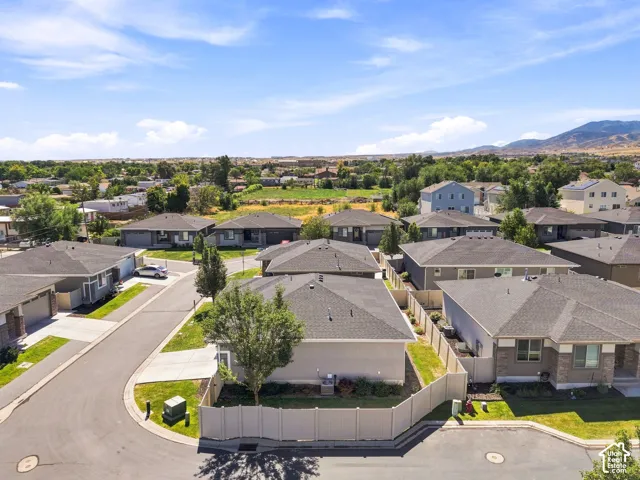 Residential neighborhood with varied rooflines and a mountainous backdrop