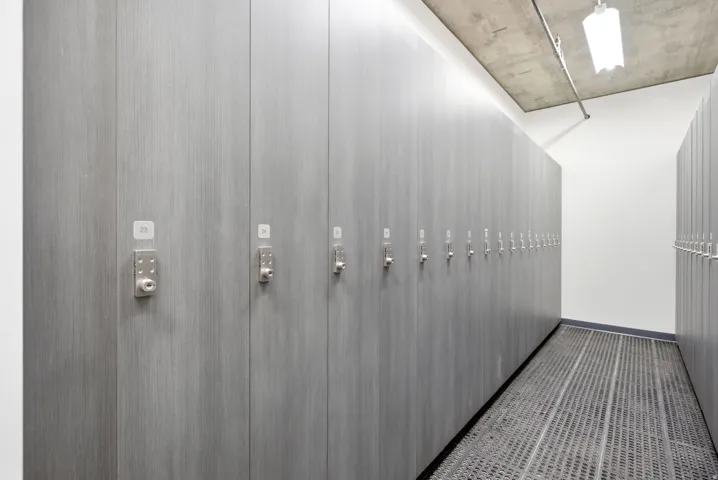 Wall-mounted storage lockers with individual locks and a concrete ceiling