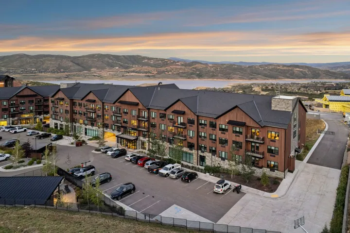 Building exterior with wood-finish siding, stone accents, and dark pitched roofs