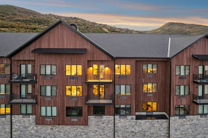 Contemporary architecture featuring wood-finish siding and a stone foundation