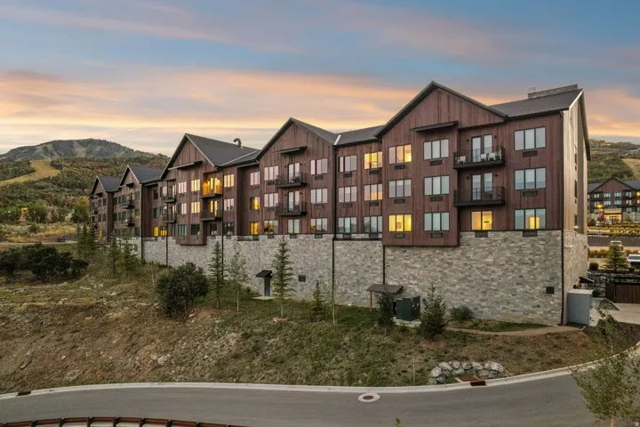 Multi-story building featuring wood siding and stone foundational elements