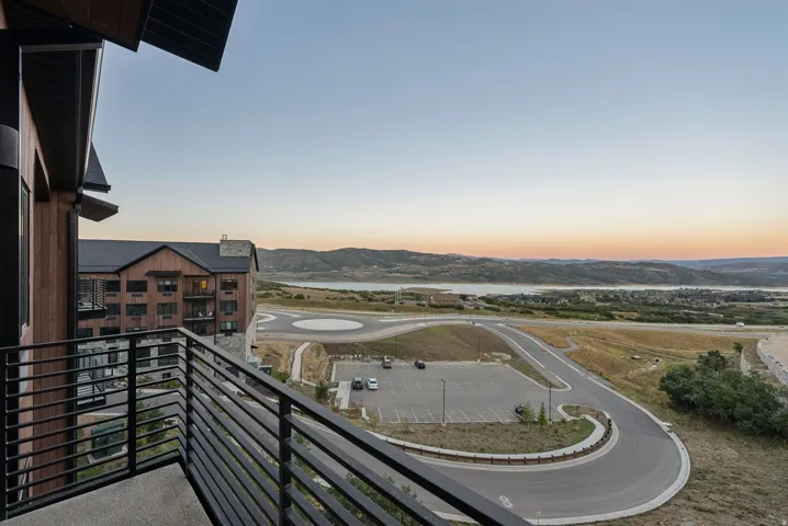 Exterior balcony featuring a metal railing and concrete flooring