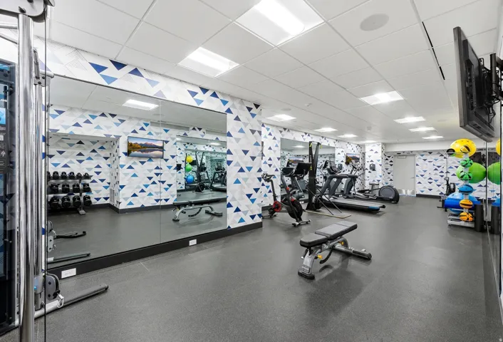 Fitness center with resilient flooring and mirrored wall panels