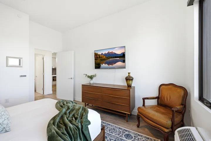 White walls, wood-finish flooring, and recessed lighting