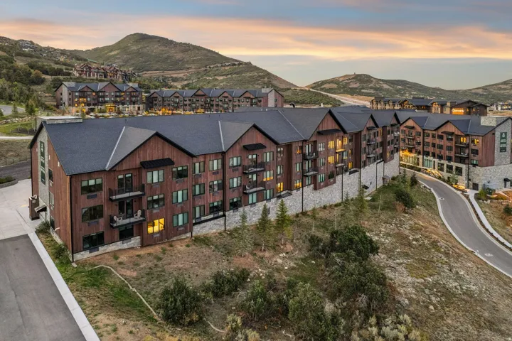 Contemporary multi-story buildings featuring wood siding and stone accents