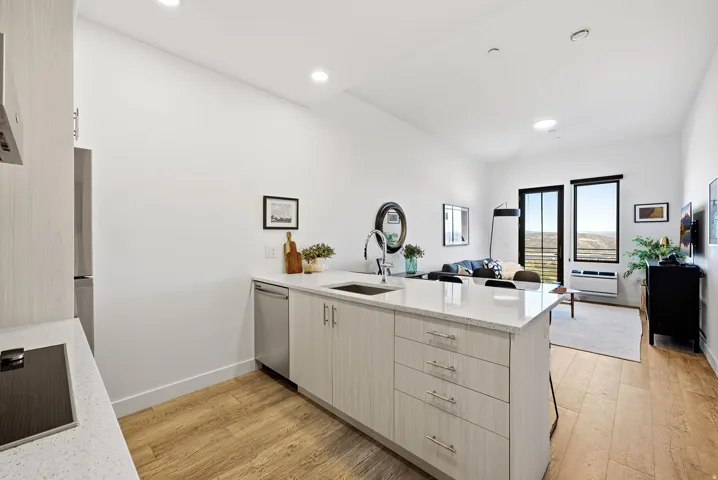 Open-concept living area with light wood-finish flooring