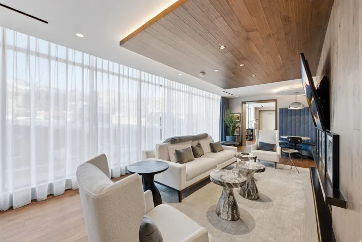 Full-height windows with sheer drapery, recessed lighting, wood-finish ceiling, and wood-finish flooring