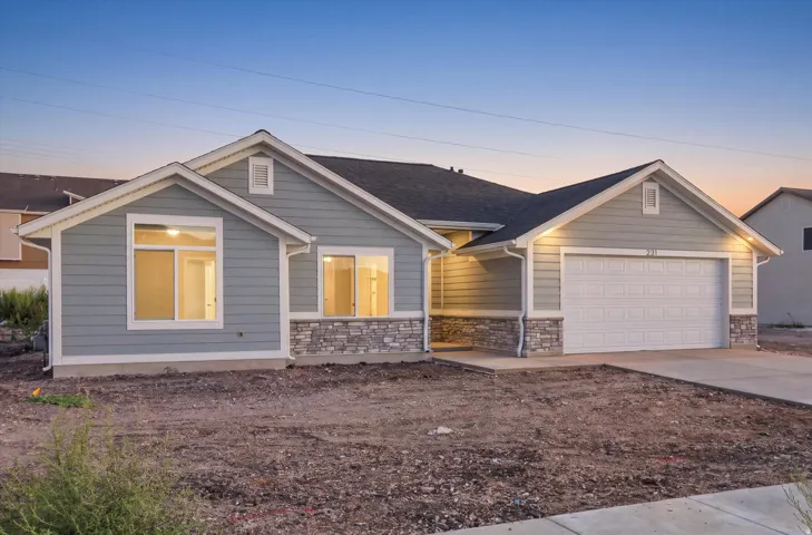 Siding exterior with stone accents and a two-car garage