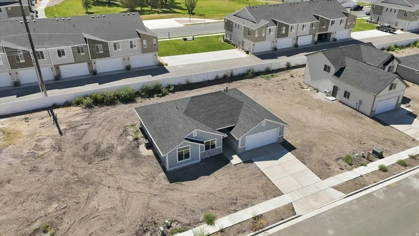 Single-story residence with light blue siding and a dark gray shingle roof