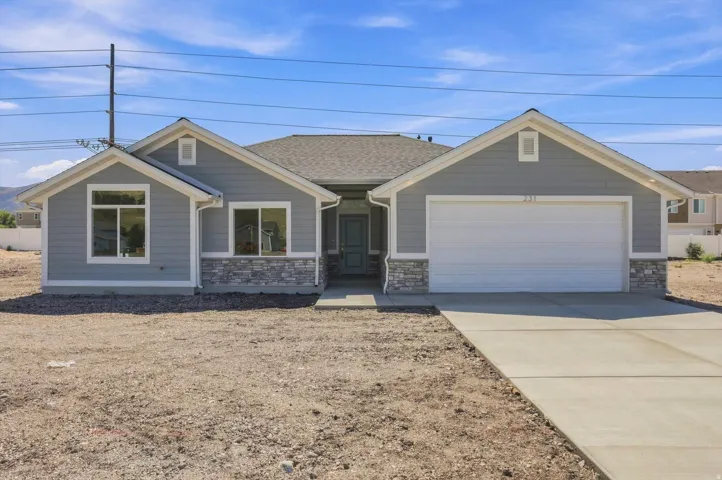 Contemporary exterior with gray siding, stone veneer accents, and a two-car garage