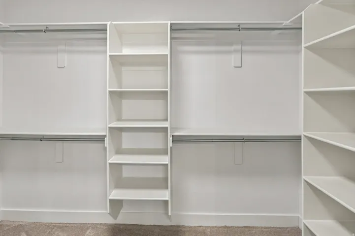 Built-in closet system featuring multiple shelves and hanging rods