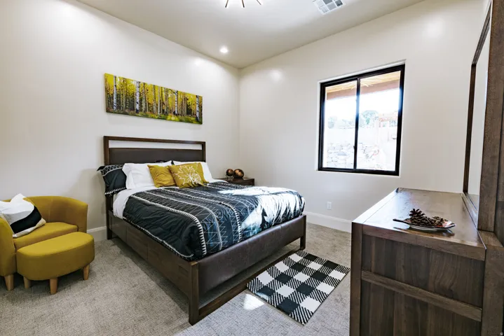 Recessed lighting illuminates neutral-toned walls and plush carpeting