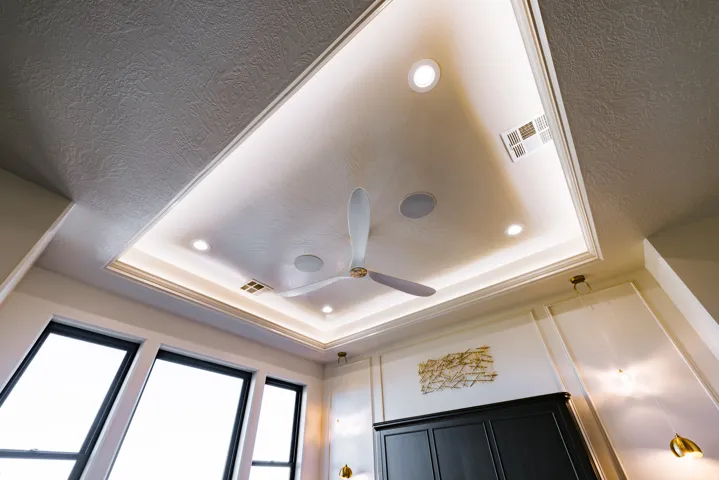 Tray ceiling with recessed lighting, integrated ceiling fan, and built-in speakers