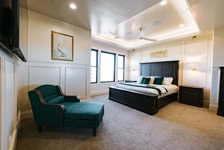 Tray ceiling with recessed lighting, integrated ceiling fan, and wall sconces