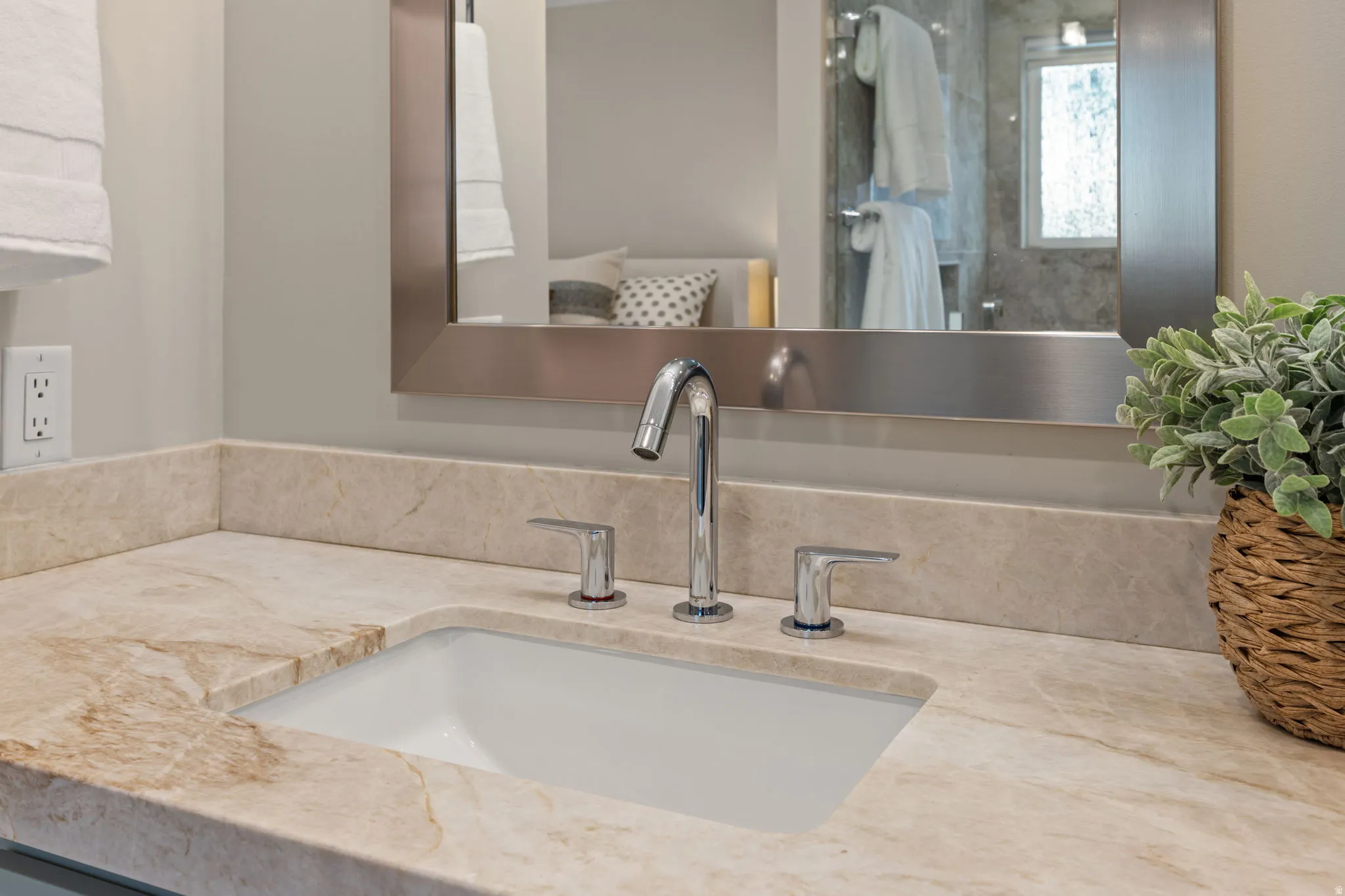Integrated vanity with an undermount sink, chrome faucet, and quartzite countertop