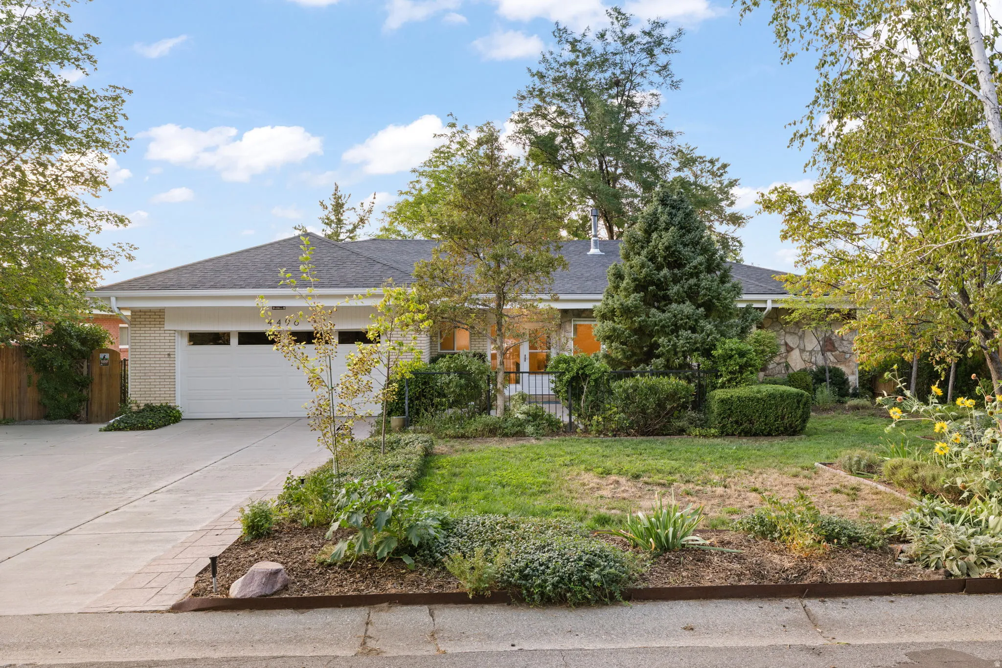 Brick exterior with attached garage and expanded parking area