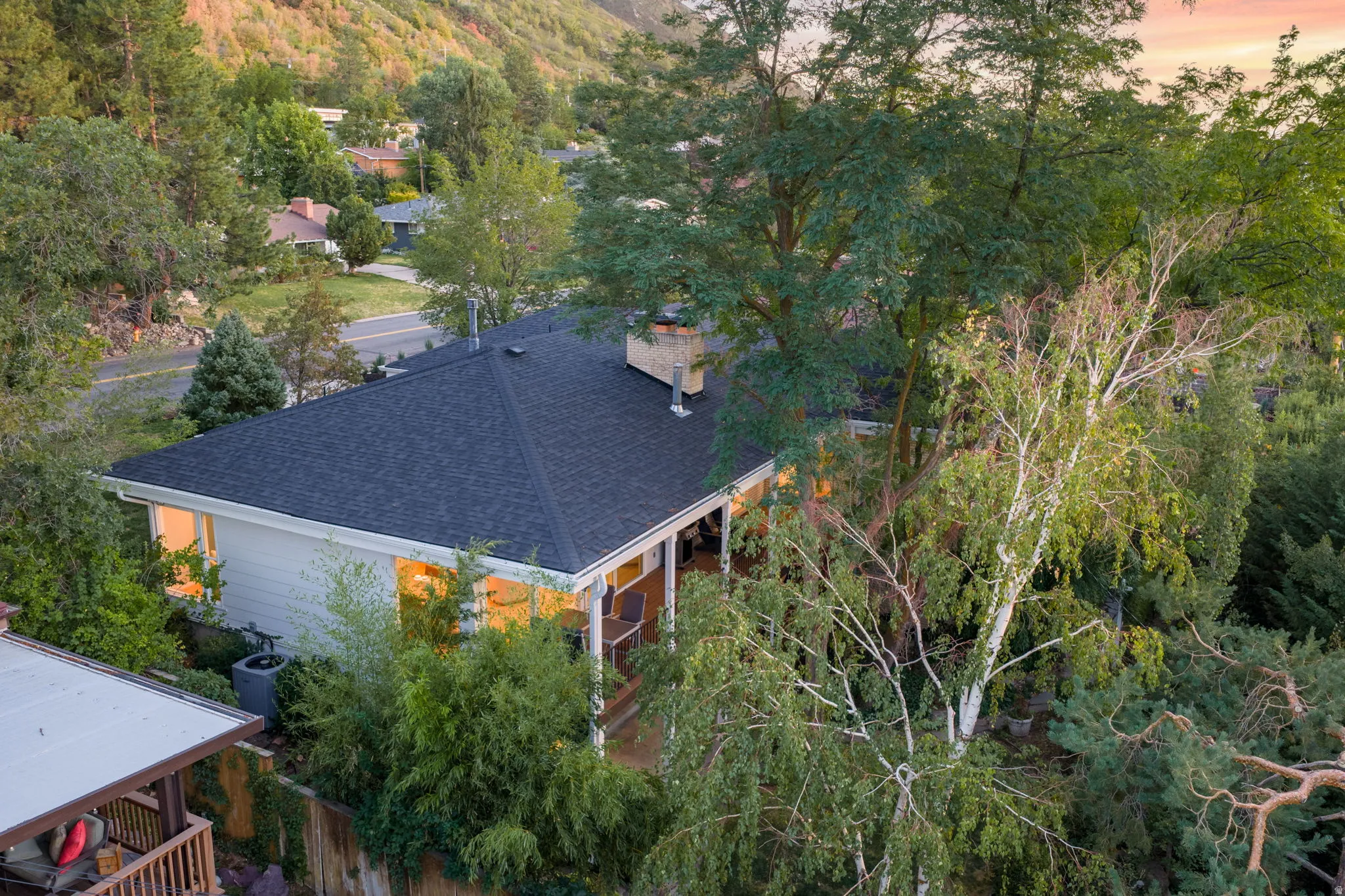 Aerial view of the home surrounded by mature trees