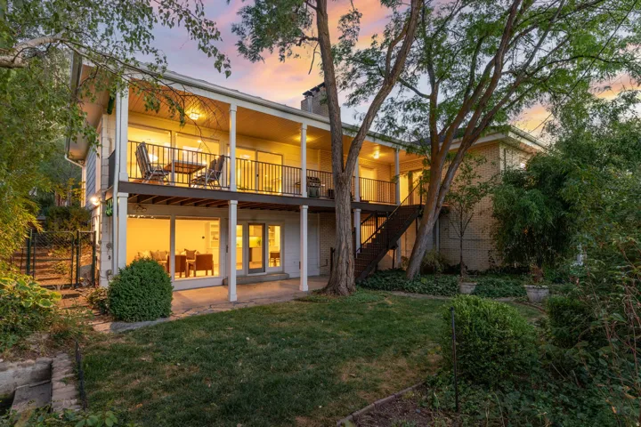 Back of home with walkouts on both levels, updated Trex deck and mature landscaping