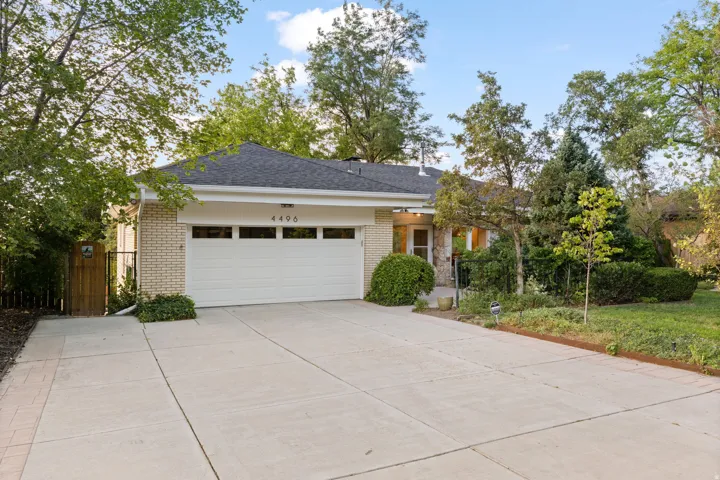 Brick exterior with attached garage and expanded parking area