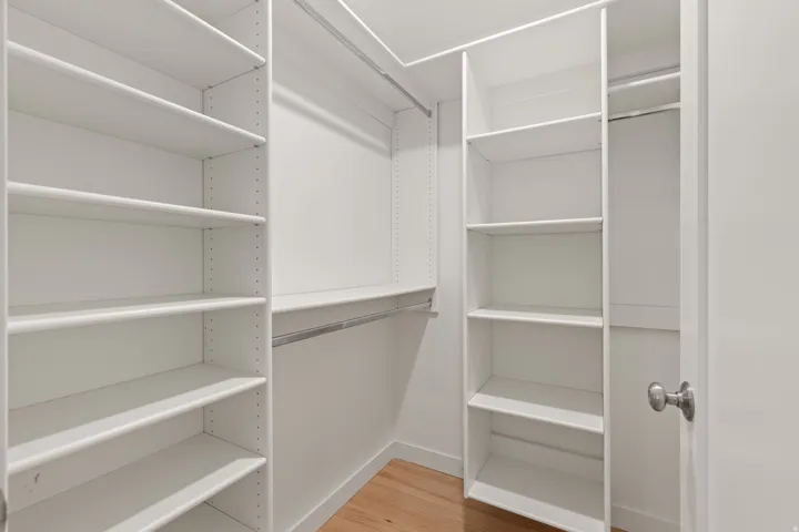 Walk in closet in lower level bedroom