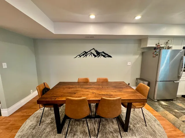 Recessed lighting, wood-finish flooring, white baseboards, and a neutral wall color