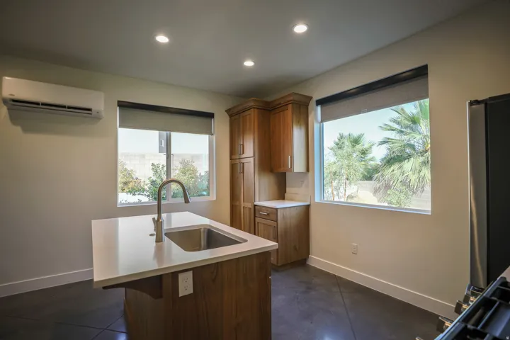 ADU - Kitchen island with an undermount sink and a gooseneck faucet