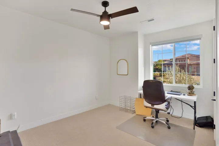 Recessed window, ceiling fan with integrated lighting, wall-to-wall carpeting, and neutral wall colors