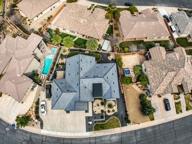 Aerial view - contemporary roofline featuring a solar panel array, with a curved driveway and desert-inspired landscaping