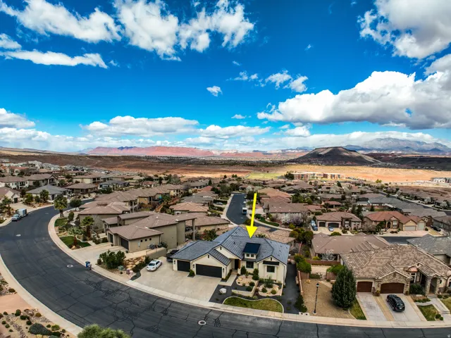 Aerial view - contemporary residence featuring a multi-car garage, and desert-adapted landscaping