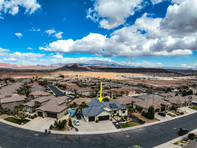 Aerial perspective showcasing a residential neighborhood with distant mountain ranges
