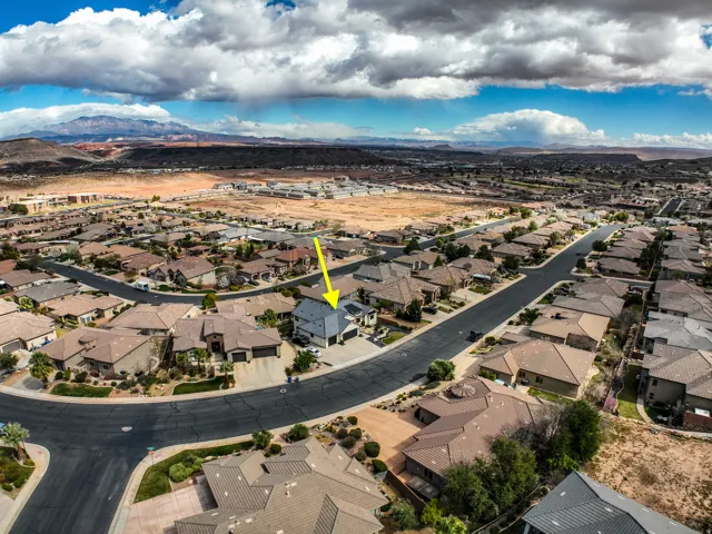 Aerial perspective showcasing a residential neighborhood with distant mountain scenery