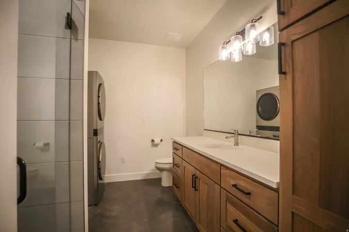 ADU - Walk-in shower with clear glass enclosure and tile surround