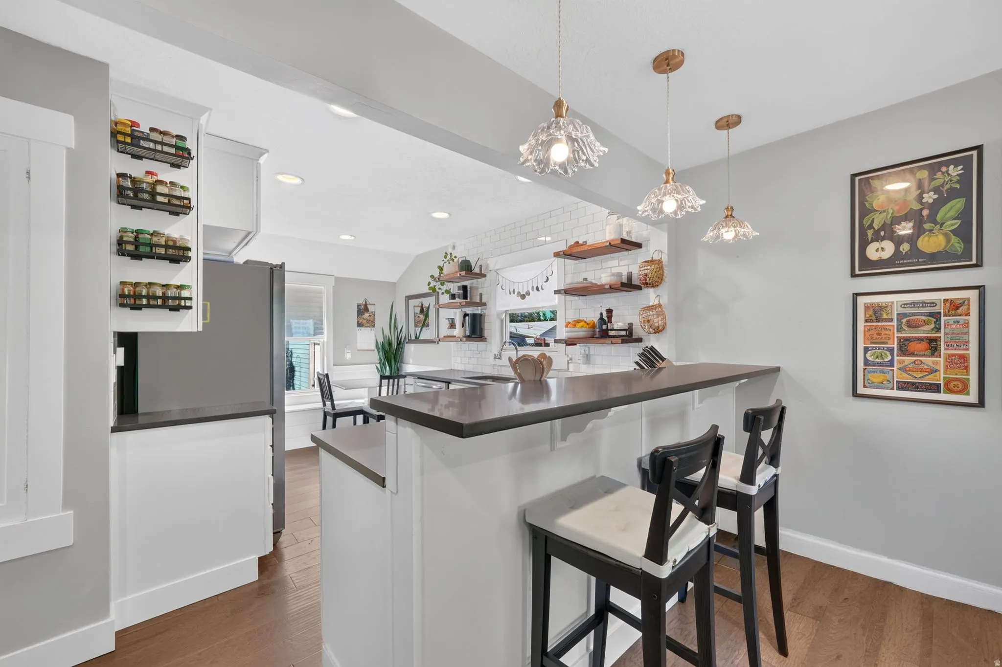 Kitchen island with a dark countertop and white cabinetry