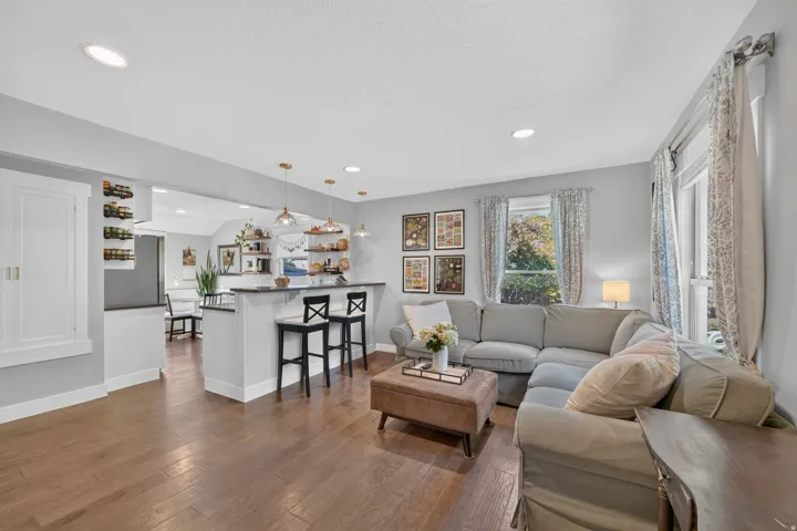 Hardwood-finish flooring, recessed lighting, and built-in cabinetry with shaker-style doors