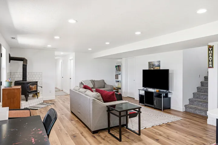 Recessed lighting illuminates the open-concept space featuring wood-finish flooring