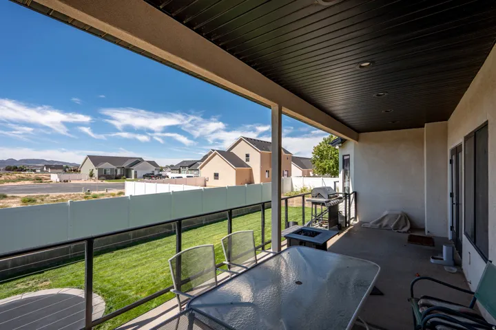 Covered patio with recessed lighting, concrete flooring, and black metal railing
