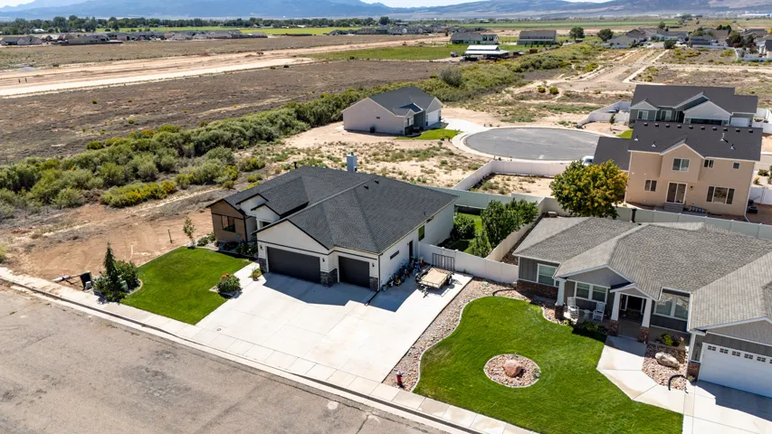 Contemporary-style residence featuring a two-car garage, concrete driveway, and front lawn