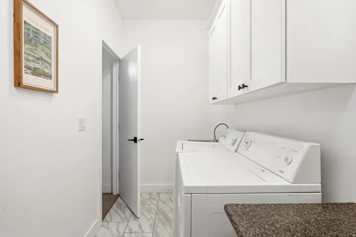 White shaker-style upper cabinetry, undermount sink, and durable countertop