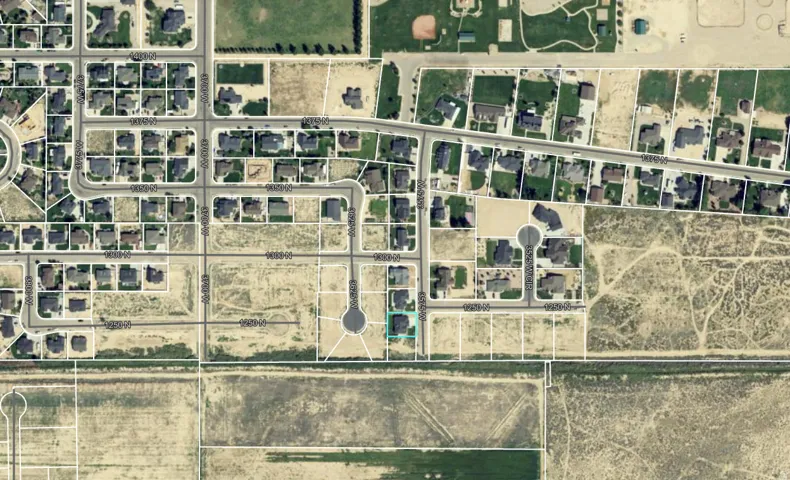Aerial Map. Depicting a residential development with individual property lines and surrounding undeveloped land