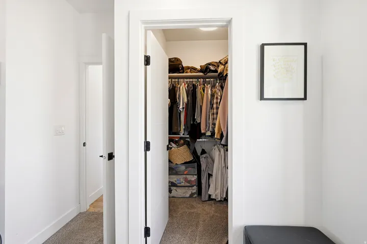 Walk-in closet with built-in shelving and hanging rods