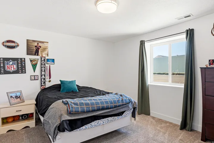 Carpeted flooring, white walls, and a window with a white frame