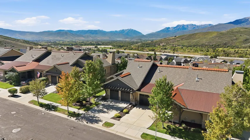 Contemporary architecture featuring a multi-car driveway, attached garages, and a pitched roof