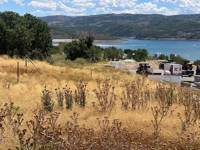 Expansive land parcel with water frontage, offering elevated mountain scenery