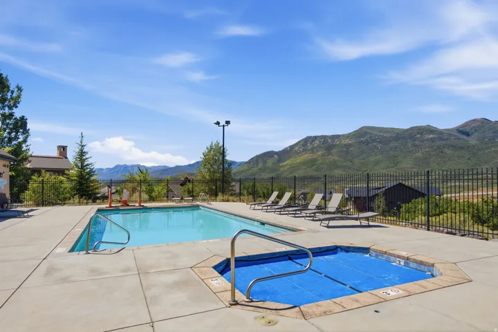 Outdoor swimming pool with a secondary covered spa